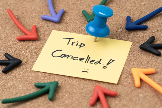 Flight Cancelled Due To COVID-19 Virus Spread Outbreak, Cancel Plan To Travel Reminder Concept, Thumbtack Pushpin With Multi Arrows Pointing To Small Paper Note Written The Word Trip Cancelled