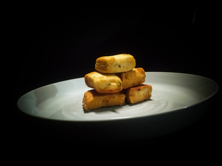 A plate of fish cake isolated on black background
