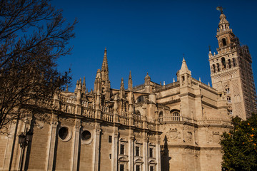 Fototapeta na wymiar Door of the Conception and The Giralda. The Cathedral of Seville, Andalusia, Spain