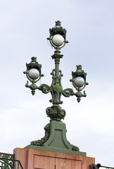 Fototapeta na wymiar Cast-iron street lamp on the bridge