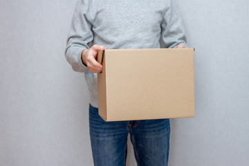 Delivery service courier with parcels in hands