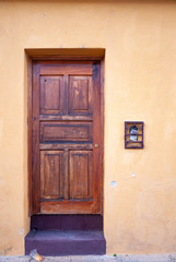 Fototapeta na wymiar Carved wooden door in colonial house of La Antigua Guatemala, exterior detail shows security and private property, access to home.