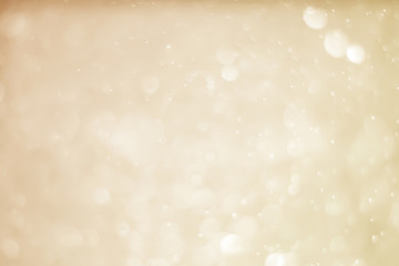 Abstract bokeh sparkle on yellow and gold background