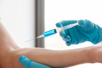 Female doctors vaccinated with syringes to prevent epidemics at hospitals, health care and medical concepts