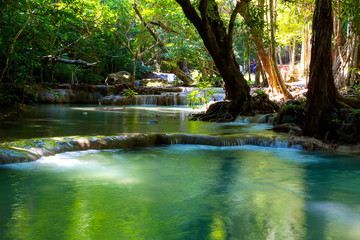 Waterfall the Erawan Waterfall with sunshine in green forest