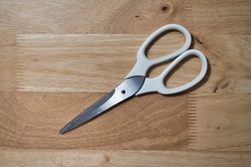 scissors on wooden background