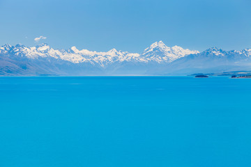 Fototapeta na wymiar Azure coloured waters of Lake Pukaki with mighty mountains range on the horizon, South Island, New Zealand