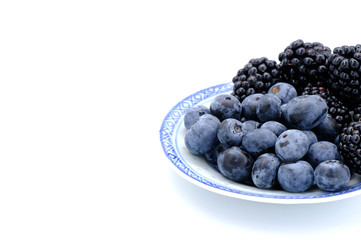 Blueberry and Blackberry on blown cup with white background, fruit concept