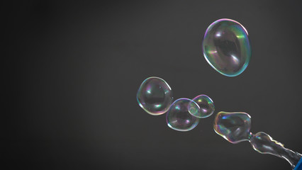 Soap or shampoo bubbles floating in the air by wind blow which represent refreshing and relaxing or...