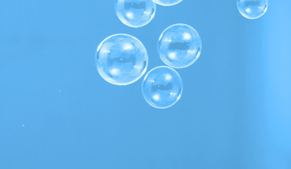 Soap or shampoo bubbles floating in the air by wind blow which represent refreshing and relaxing or joyful mood and tone and shoot in clear background in studio lighting set.