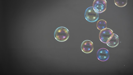 Soap or shampoo bubbles floating in the air by wind blow which represent refreshing and relaxing or joyful mood and tone and shoot in clear background in studio lighting set.