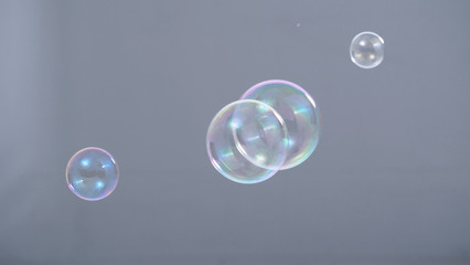 Soap or shampoo bubbles floating in the air by wind blow which represent refreshing and relaxing or joyful mood and tone and shoot in clear background in studio lighting set.