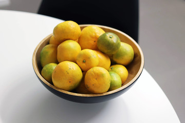 Tangerine in a wood bowl