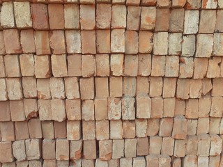Rows of orange colour bricks laid on each other. Bricks pattern background