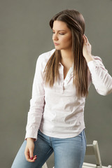 Beauty portrait of young brunette in classic white shirt. Studio shot of young beautiful woman.