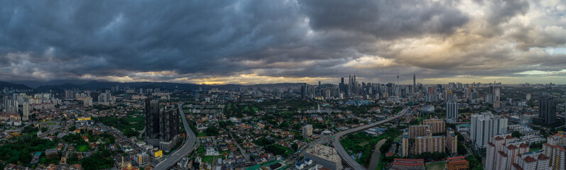 Fototapeta na wymiar Aerial Panoramic view of Kuala Lumpur with rain clouds during day time.