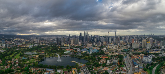 Aerial Panoramic view of Kuala Lumpur with rain clouds during day time.