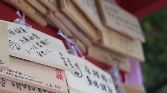 Japanese wooden plagues (Ema) hanging up at the shrine