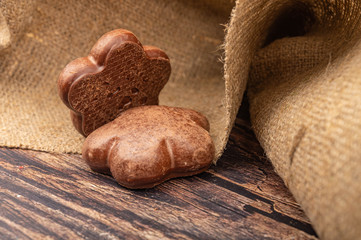 Chocolate gingerbread on a background of rough homespun fabric. Close up.