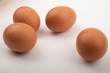 Chicken eggs scattered on a white background. Close up.