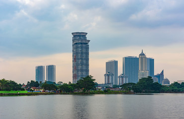 Tangerang, Indonesia - 5th January 2018: A view of Kelapa Dua Lake in the foreground and Lippo Karawaci district buildings in the background. Taken in a cloudy afternoon. Property investment.