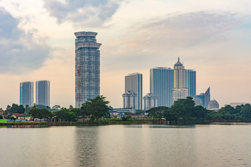 Tangerang, Indonesia - 5th January 2018: A view of Kelapa Dua Lake in the foreground and Lippo Karawaci district buildings in the background. Taken in a cloudy afternoon. Property investment.