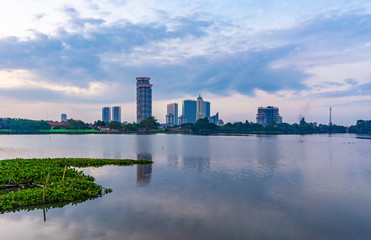 Tangerang, Indonesia - 5th January 2018: A view of Danau Kelapa Dua (Kelapa Dua Lake) on the foreground and Lippo Karawaci district buildings in the background. Taken in a cloudy afternoon.