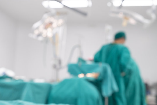 Blurred image background of medical team performing surgical operation in operating room. An operating room may be designed and equipped to provide care to patients.