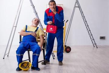 Two contractors in first aid concept