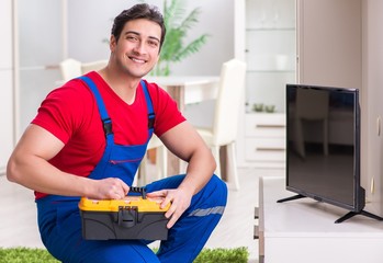 Fototapeta premium Professional repair engineer repairing broken tv