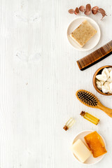 Fototapeta na wymiar Cosmetics for hair care with argan and jojoba oil on white background top-down frame copy space