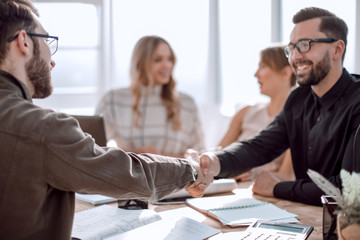 smiling businessman at a working meeting in the office