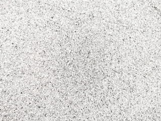 Top view of texture fine sand beach in sunny day. Beautiful white sand surface for backgrounds and wallpapers