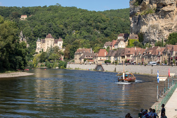  Canoeing and tourist boat, in French called gabare, on the river Dordogne at La Roque-Gageac and...