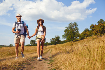 Couple travelers with backpack on hike in nature