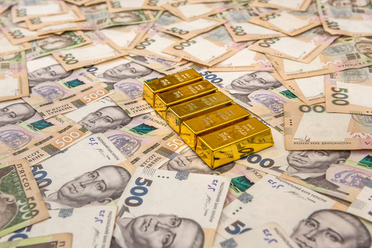 stacks of gold bars on ukraine moneu uah . top view