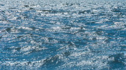 Shiny ripple on the surface of the sea water surface. Selective focus.