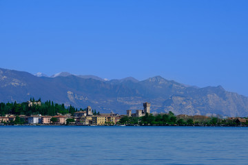 Fototapeta na wymiar Sirmione island Lake Garda, Italy. In the background mountains and blue sky