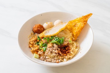 spicy noodles with fish ball and minced pork (Tom Yum Noodles)