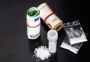 Cocaine on a dark plate (close-up shot)