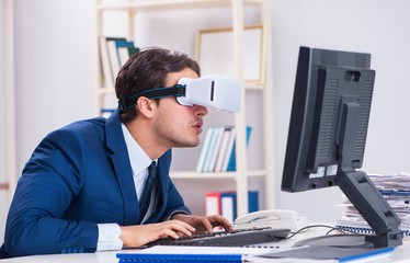 Employee using virtual reality glasses in office