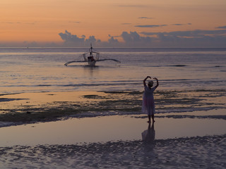 silhouette of surfer on beach at sunset