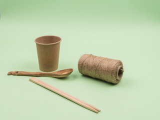 Household items made of ecological materials on a green background.