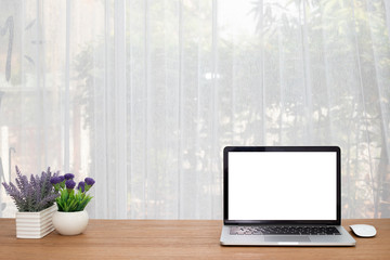 Blank screen for text on notebook and flower pot.