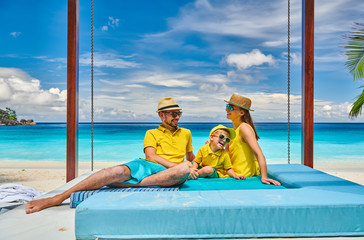 Family with three year old boy on beach. Seychelles, Mahe.