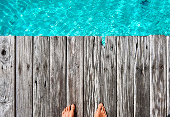 Man standing on boardwalk jetty