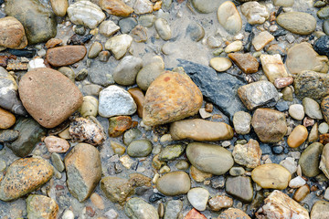 Background of pretty pebbles stone on the beach .