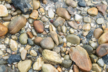 Background of pretty pebbles stone on the beach .
