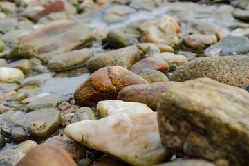 Background of pretty pebbles stone on the beach .