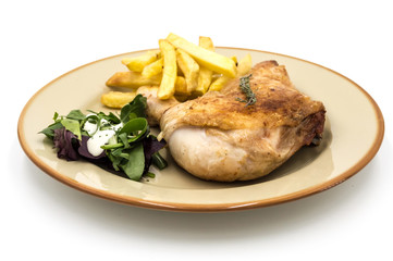 Roasted chicken leg with fries and vegetables